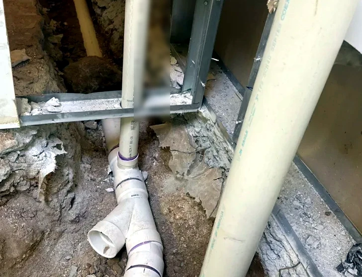 PVC drain and sewer rough-in exposed during construction
