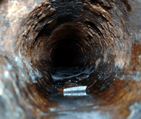 Interior view of an aged drain or sewer pipe