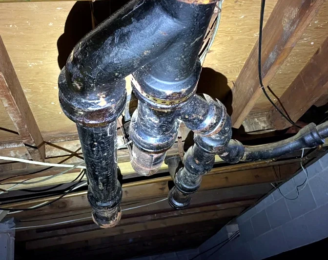 Existing cast iron drain piping below a floor