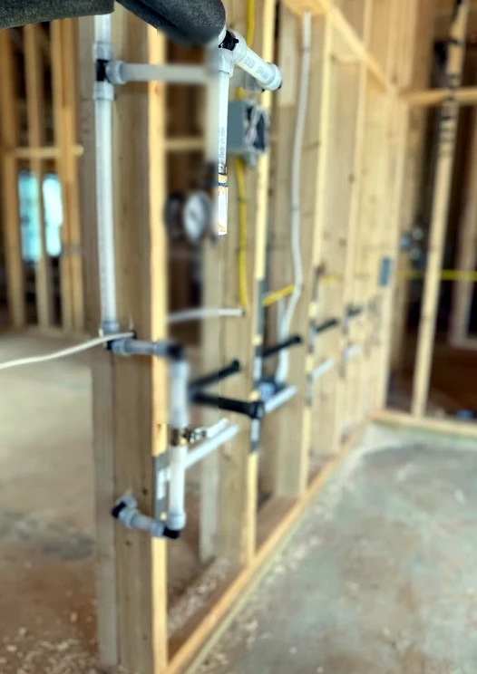 New construction plumbing rough-in with pressure gauge