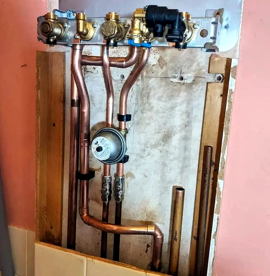 Copper valve and manifold plumbing inside an open wall