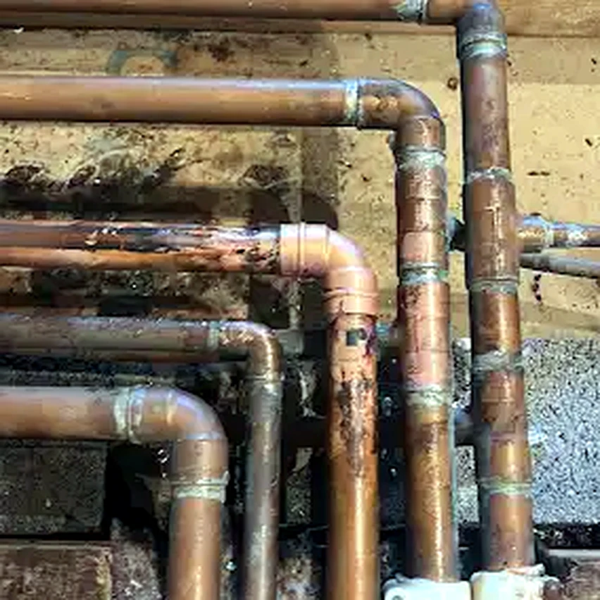 Aged copper piping with multiple fittings and joints